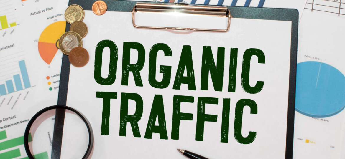 Organic seo traffic - text on a notebook with a spring and a gray handle.
